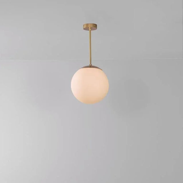 Glass globe opal 30 pendant light by schwung dimensions: w 30 x d 30 x h 65 cm materials: natural brass, hand blown glass...