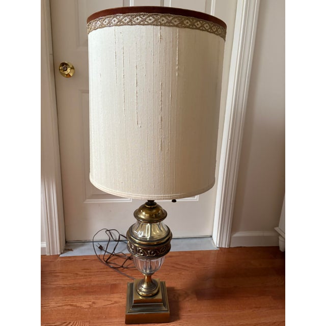 A pair of vintage Stiffel Hollywood Regency brass and glass table lamps, probably 1940s. Each comprising a thumb-molded...