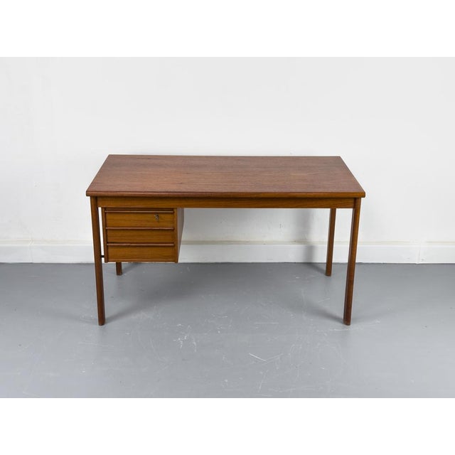 High-quality teak desk from Denmark with three drawers and a sliding worktop with hidden compartments underneath. Very...