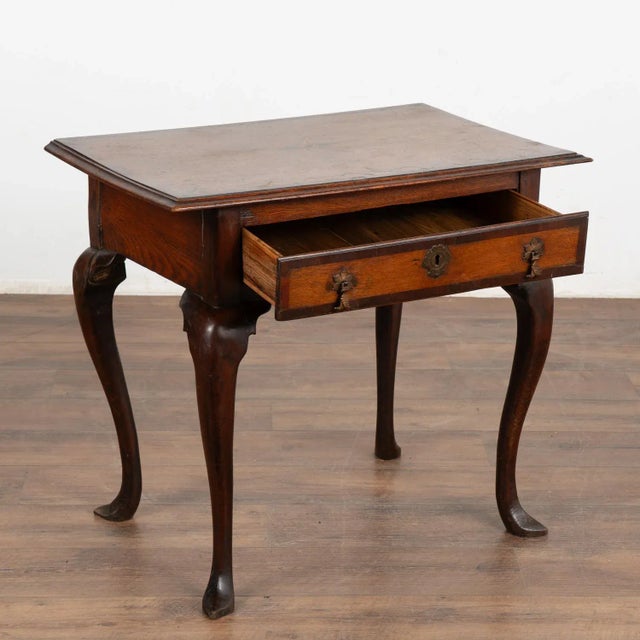 Oak side table with curved cabriolet legs, inlaid decorative starburst pattern and walnut trim. Please enlarge photos to...