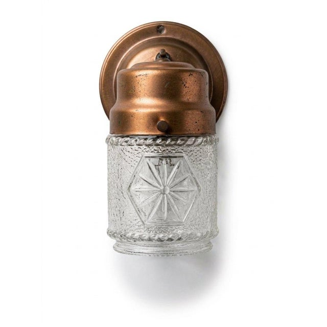 Puritan vintage wall sconce with a warm copper finish and textured glass shade. The geometric detail adds a subtle Art...