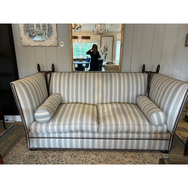 Classic knole style sofa by the luxury furniture maker George Smith having wooden finials, down seat cushions, matching...