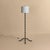 A French iron chain floor lamp from the 1960s. The vertical form is composed of linked iron elements, rising from a three-...