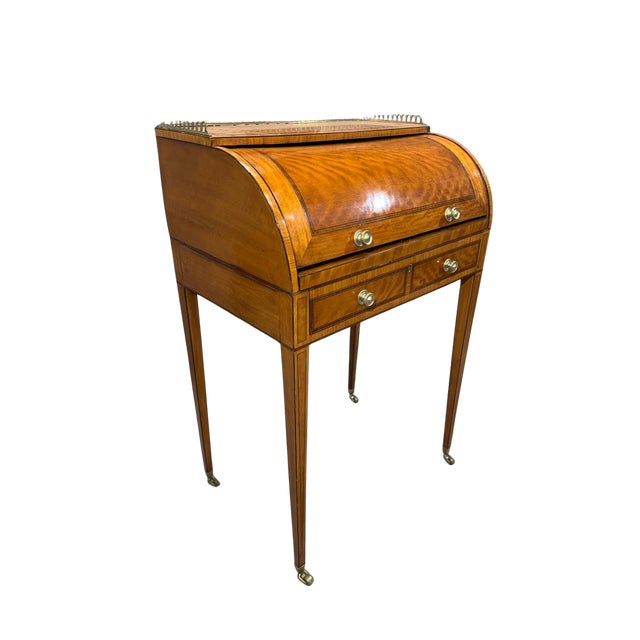 Elegant satinwood roll top desk featuring a beautifully figured tambour front and fine line inlay throughout. The interior...