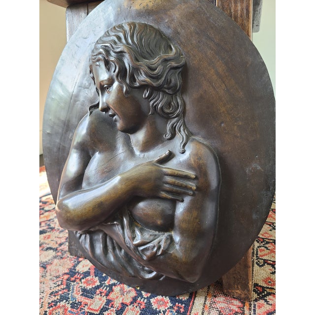 Early 20th century bronze bas-relief depicting a classical draped female figure holding her hand across her chest. Signed...