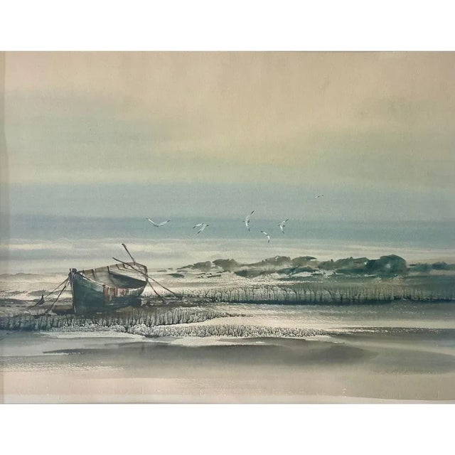 An original framed seascape watercolor on paper painting of a boat at low-tide by the talented artist, Suraprison. The...