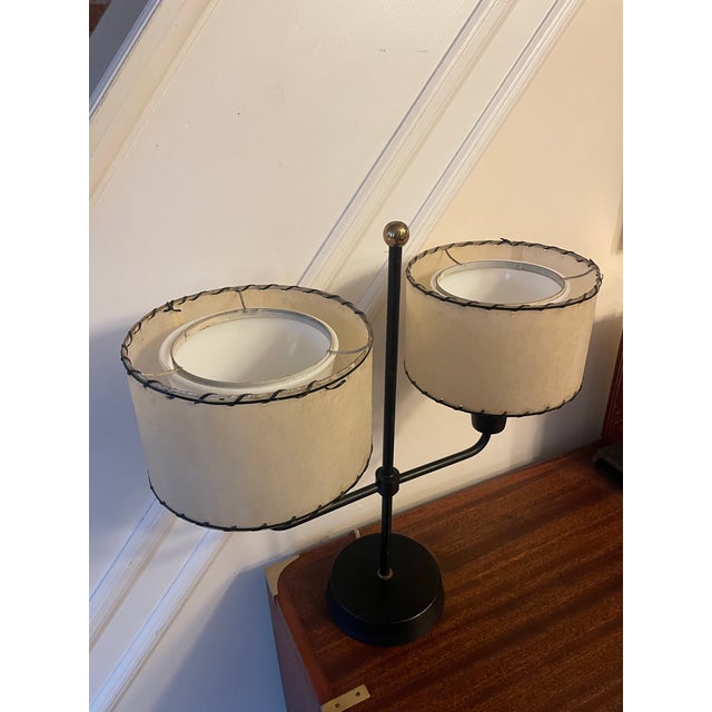 In the style of Paul McCobb's black enameled steel "Student Lamp" (Model no. 2008 table lamp) for Northcraft. The...