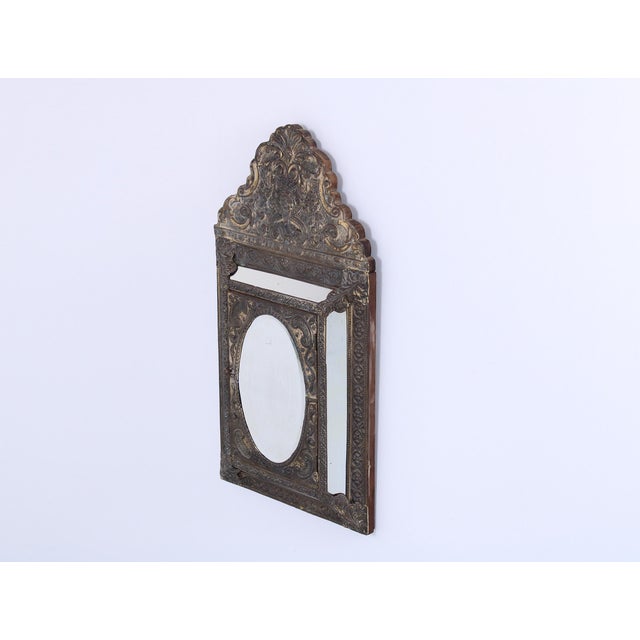 Charming 1930s mirror in baroque / neo classical style. It has a small cabinet in the centre, with a door. It cleary...