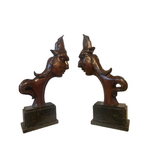Striking pair of hand-carved sculptural architectural elements dating to the Art Deco period. Each figure features an...