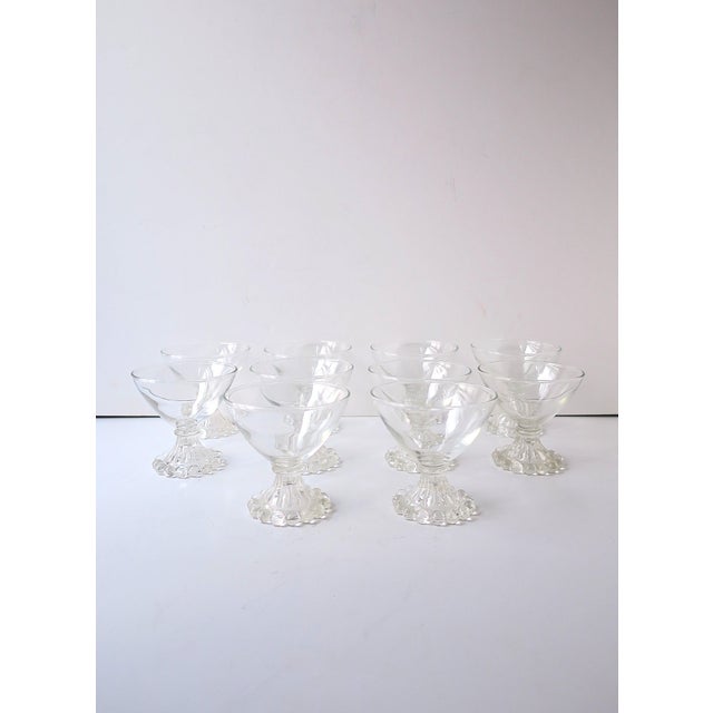 A set of ten (10) clear glass Champagne or cocktail coupes, or dessert glassware, featuring clustered bubble bases,...