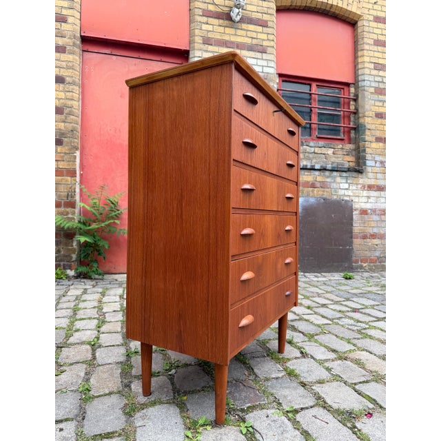 A masterpiece of Scandinavian craftsmanship: This Danish mid-century chest of drawers from the 1960s perfectly combines...