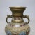 An antique Japanese Persian style vase set offers Champlevé enameled bronze urn form vessels with figural double handles,...