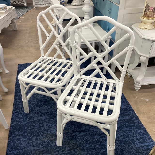 A pair of vintage Chippendale style rattan dining chairs but more bistro sized than a regular rattan dining chair. These...