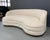 A kidney-shaped sofa that features a nice sculptural modern design, with a curved arched back. These sofas are newly...