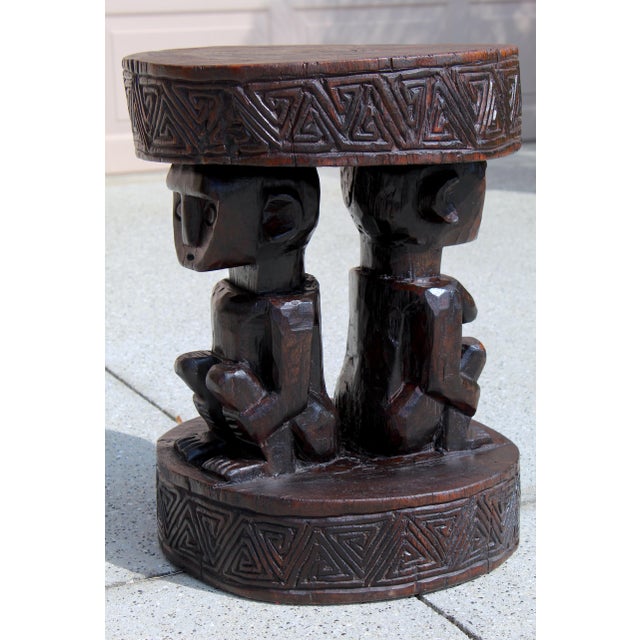 Authentic vintage hand-carved African figural stool featuring a male and female figure seated back-to-back, supporting a...