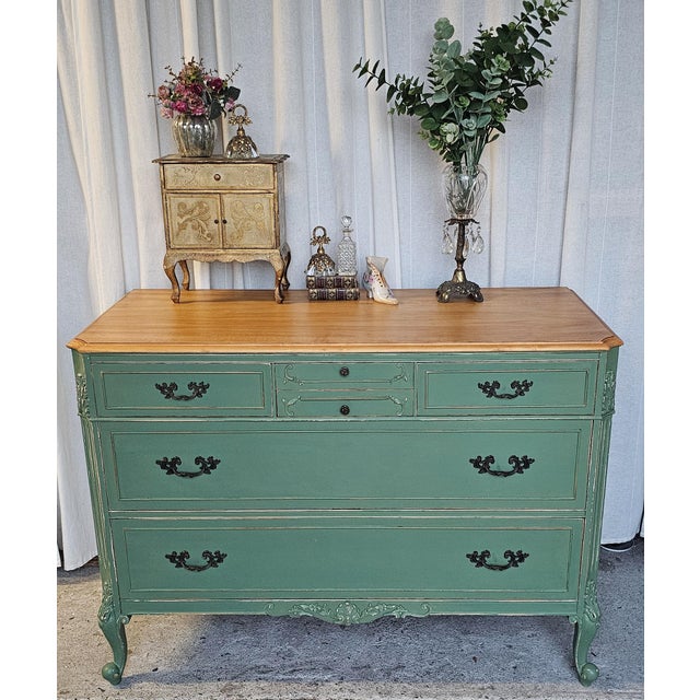 This antique French provincial style dresser, Burl Wood, customized on a custom green color, heavily distressed and wax...