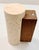 Minimalist wall sconce featuring a solid travertine stone cylinder paired with a warm wood backplate. This compact 6.4″...