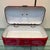 Vintage red enameled steel bread box from the 1950s, originating from the Netherlands. This charming box has a white...