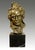 This bronze bust portrays Beethoven with a focused expression and modeled curls, set on a dark marble base. This is a...