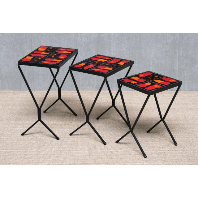 This rare set of three nesting tables was produced in france in the 1950s. The design is strongly reminiscent of the...