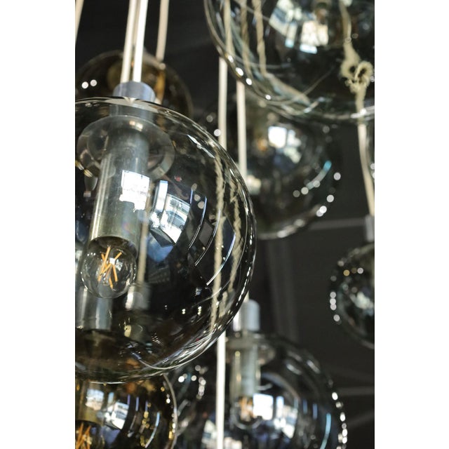 Monumental 16 globe cascade chandelier by Lightolier, circa 1970s. Blown glass bulbs in various sizes cascade nearly 10...