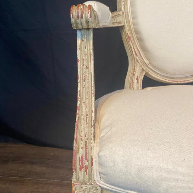 Classic 19th century French Louis XV style cream painted walnut armchairs newly upholstered in a high end complementary...