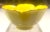 This beautiful hand decorated yellow bowl in the shape of a lotus flower has raised white floral artwork on its inner and...