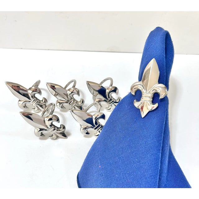 Fleur-de-lis napkin rings set of 6 in polished silver tone, a classic French-inspired tabletop accent ideal for formal...