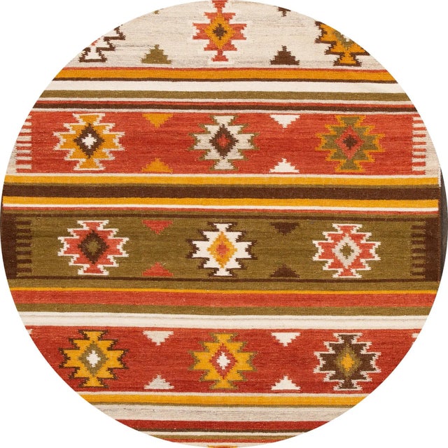 A beautiful hand-woven modern Kilim rug with an ivory field and multi-color accents in an all-over geometric design. This...