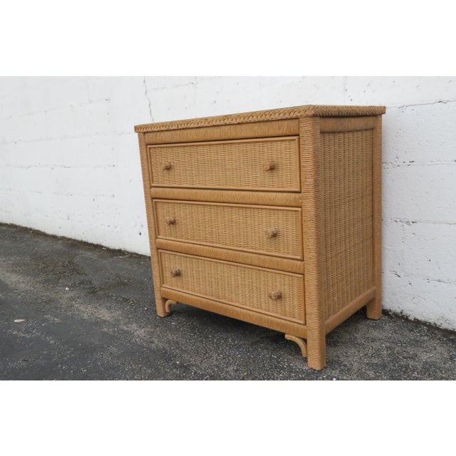 This Small Chest of Drawers is made out of wood, wicker, rattan, and Glass. This Large Nightstand has Hollywood Regency...