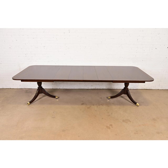 An exceptional Georgian or Regency style double pedestal extension dining table By Kindel Furniture USA, Circa 1980s...