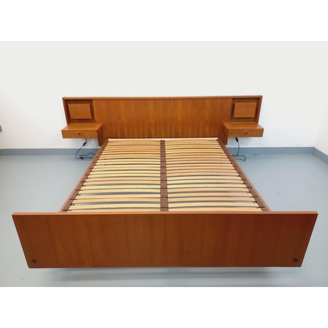 Vintage Scandinavian-style double bed from the 1960s, made of teak, with integrated headboard, frame, footboard, and...