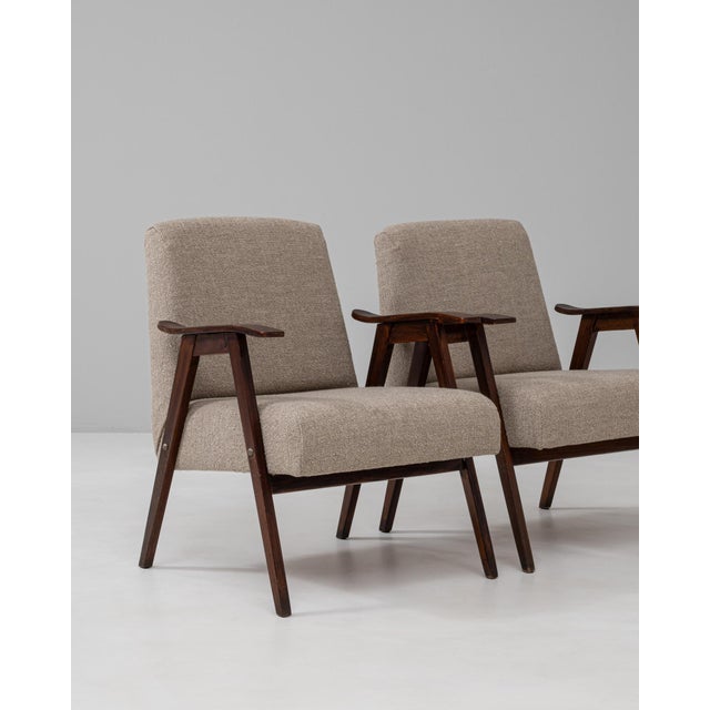 This pair of 1960s Czech upholstered armchairs reflects the clean, functional aesthetic of mid-century design from Central...