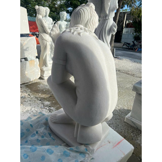 Crouching Venus captures the graceful movement and intimate beauty associated with classical representations of the...