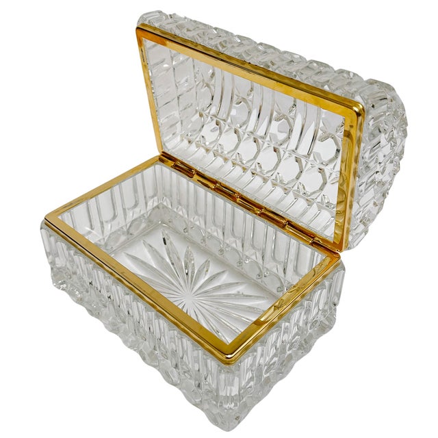 A large domed crystal casket with high-clarity hand-cut crystal featuring a treasure chest silhouette. The heavy domed lid...