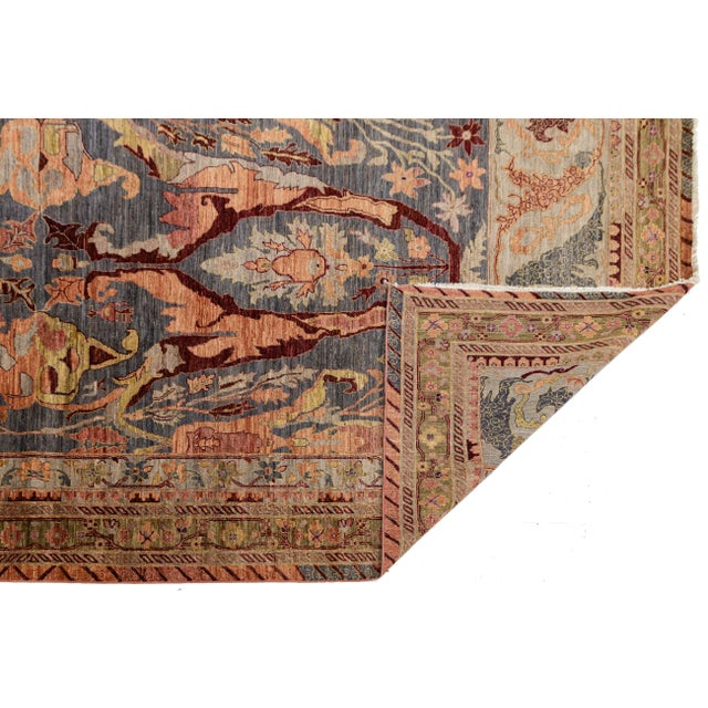 Elevate your space with this exquisite hand-knotted wool rug inspired by the "Iron Rugs" of Bidjar. It features bold...