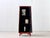 A striking, narrowly proportioned chinese wedding cabinet with a vibrant red lacquer finish and traditional-style metal...