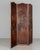 A Spanish Baroque style leather three panel folding screen, hand-painted in rich warm shades of red and brown with large...