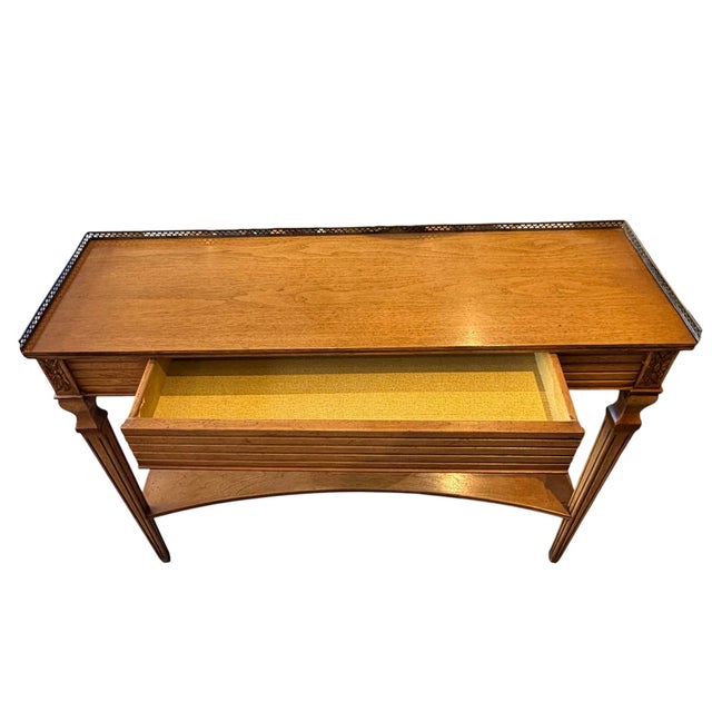 This elegant French Neoclassical-style console table brings a touch of timeless sophistication to any entryway, hallway,...