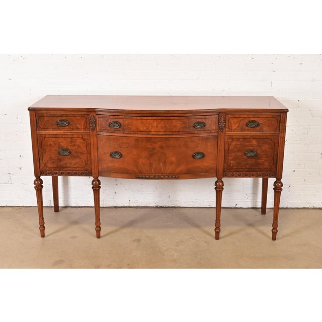A gorgeous French Regency Louis XVI style sideboard, credenza, or buffet In the manner of Baker Furniture USA, Circa 1940s...