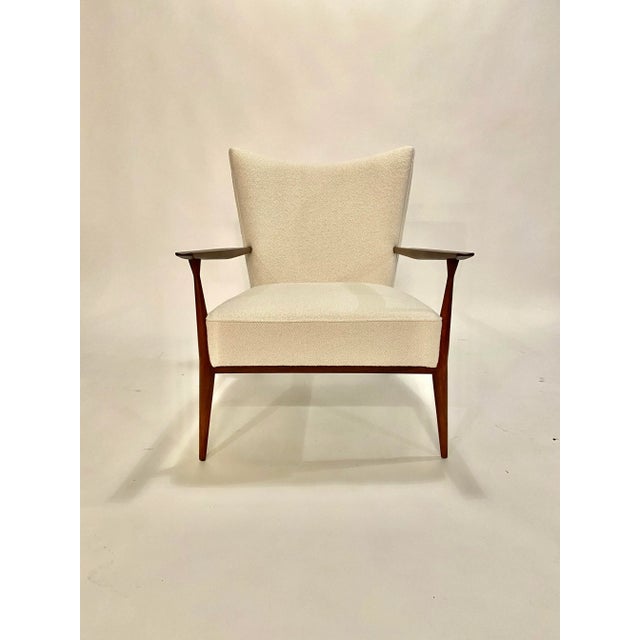 1950's Paul McCobb lounge chair in beautifully restored walnut and reupholstered in an Italian ivory boucle. This chair is...