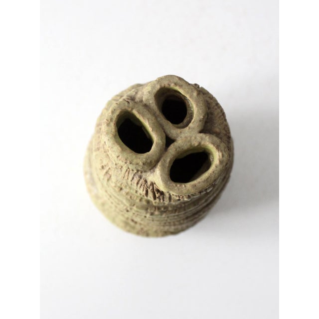 This vintage handmade studio pottery vase features a sculptural silhouette and richly textured surface. A layered green...