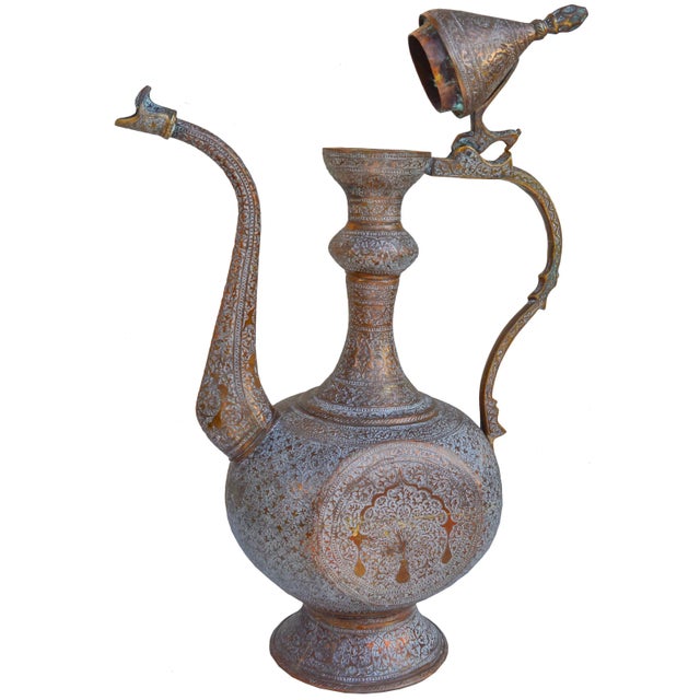 Antique handmade solid copper pitcher with ornate hand-hammered and engraved designs. This beautiful accent ships within...