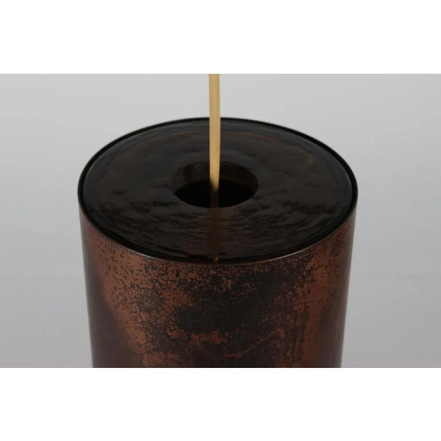 Pendant light made of amber coloured glass covered with patinated copper with perforrations in Nanny Still style 1960s by...