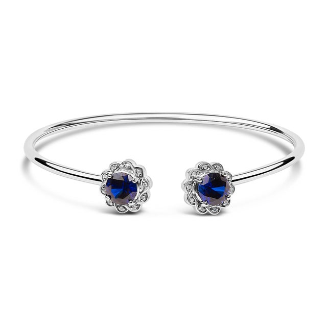 Immerse yourself in the timeless elegance of this .925 sterling silver bangle, where contemporary design meets classic...
