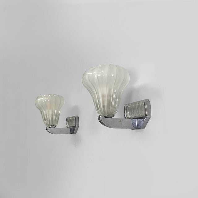 Italian Art Deco wall lamps in glass and metal, 1930s Pair of wall lamps with conical glass diffusers. The frame is metal,...