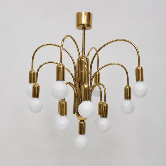 Bring warmth and elegance to your interior with this beautiful vintage gold chandelier from the 1970s. The lamp is a true...