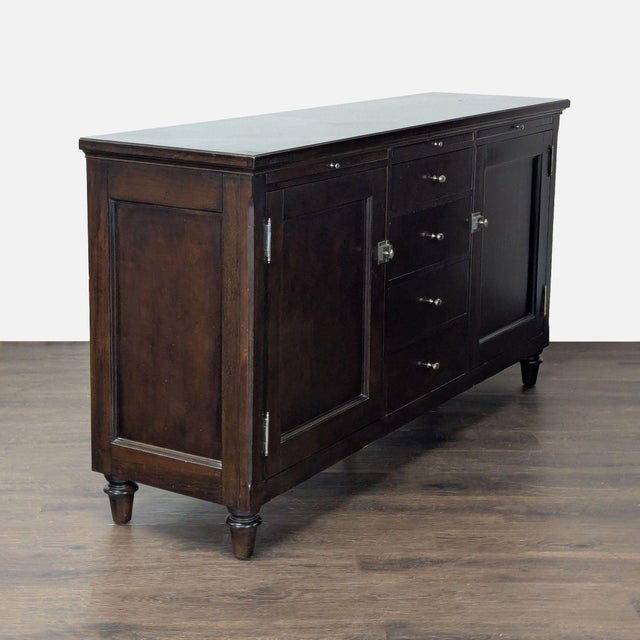 This Bernhardt sideboard features a rich dark wood finish and classic design. It offers generous storage with two large...