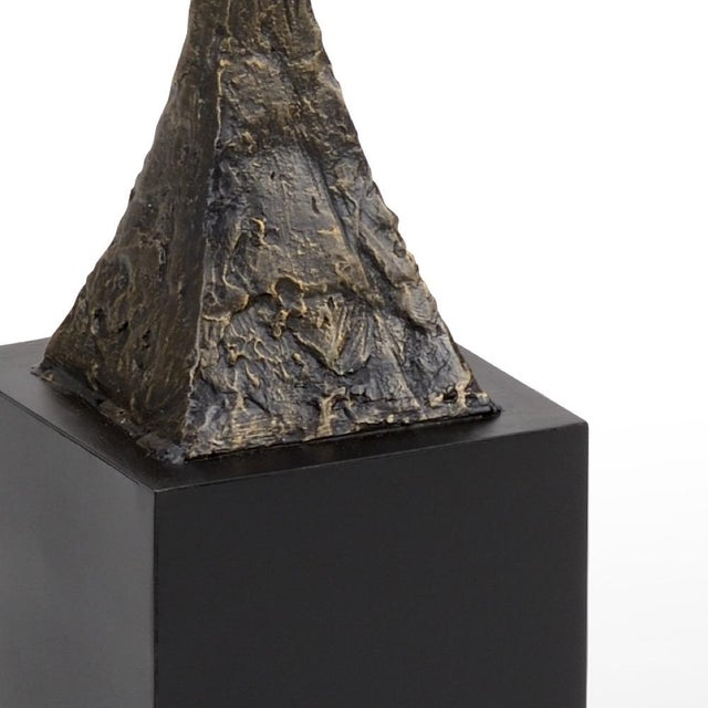 Iron sculpture with bronze finish and natural black stone base 65.3h x 8w x 8d