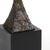 Iron sculpture with bronze finish and natural black stone base 65.3h x 8w x 8d